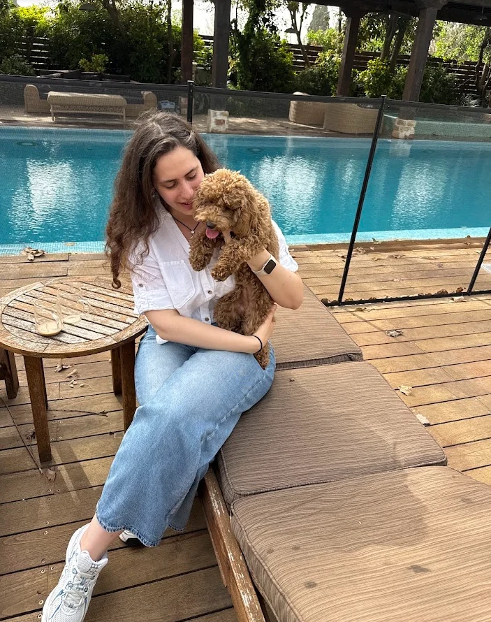 Chupa being held during a relaxed poolside moment